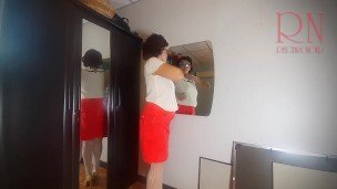 A naked lady does make-up in front of a mirror, puts on underwear, stockings, a skirt. 3