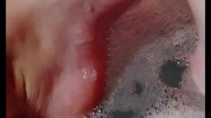 Hot blonde massaging her wet soapy feet in the bath